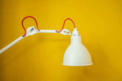 Close-up of lamp on yellow background