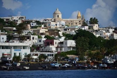 Boats in river with buildings in background