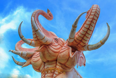 Low angle view of angel statue against blue sky