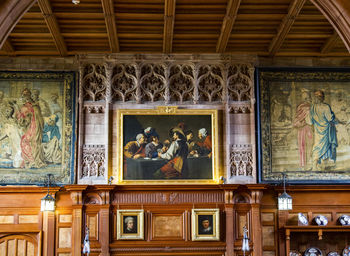 Low angle view of statues on ceiling of building