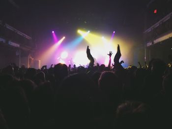 People enjoying at music concert during night