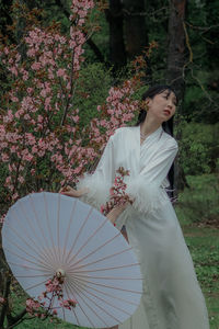 Portrait of woman holding umbrella