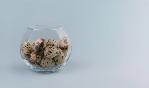 Close-up of drink in glass against white background