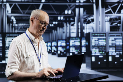 Portrait of man using laptop on table