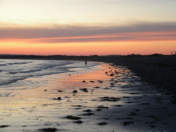 Scenic view of sea against sky at sunset