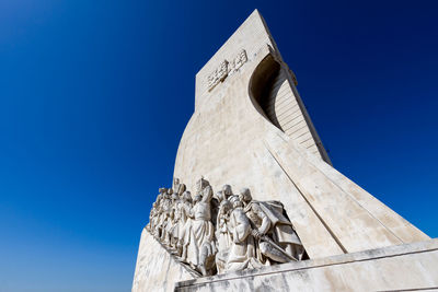 Low angle view of statue against clear blue sky
