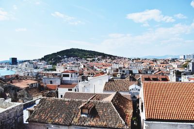 High angle view of houses in city against sky