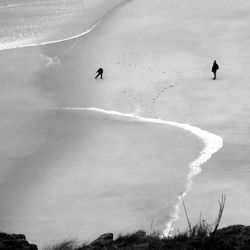 People in mid-air on land against sky