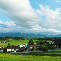 Houses on field against sky