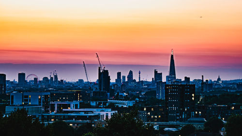 Cityscape against sky during sunset