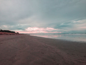 Scenic view of beach against sky during sunset