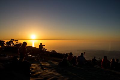 People on beach at sunset