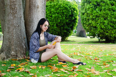 Young woman sitting on field