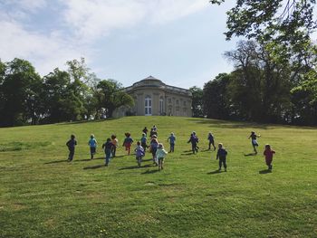 Children running towards building on field