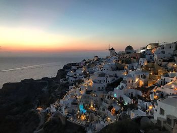 High angle view of townscape by sea against sky