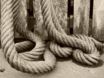 Close-up of rope tied on wooden post