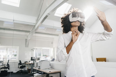 Woman wearing vr glasses in office