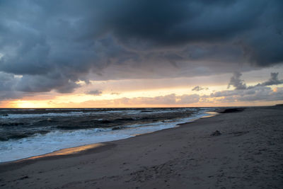 Scenic view of beach against sky during sunset