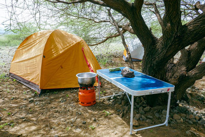 Camping tent, stove and table in the wild at shompole consevancy, kenya