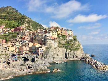 Panoramic view of townscape by sea against sky