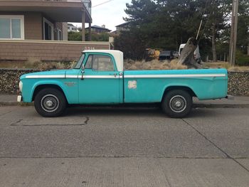 Side view of car on street against building