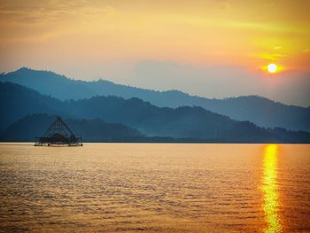 Scenic view of sea against orange sky