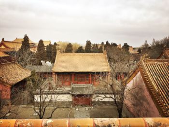 High angle view of building and trees against sky