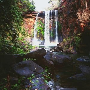 Stream flowing through rocks in forest