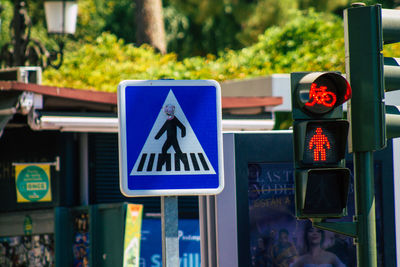 Close-up of road sign against blue city