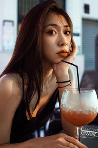 Portrait of woman drinking glass