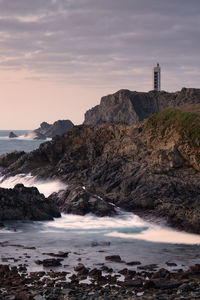 Vertical shot of the meirás lighthouse and surrounding cliffs