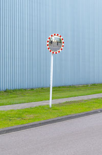 Road sign on grass in city