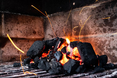 Bbq in an enclosed bbq pit with sparks flying