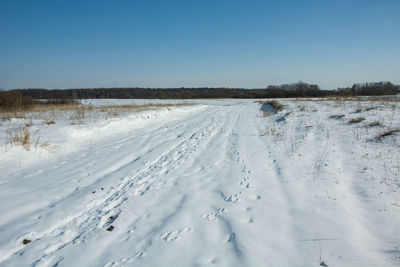 Snow covered field against sky