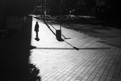 Man walking on street at night