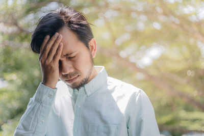 Man suffering from headache outdoors