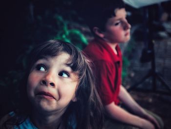 Portrait of siblings standing outdoors