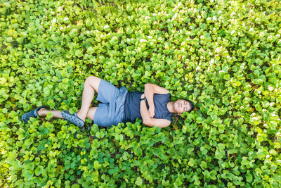 High angle view of child lying on grass