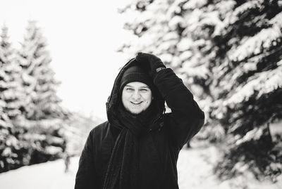 Portrait of smiling young man in snow