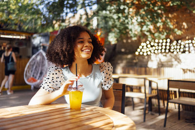 Young woman sitting on table