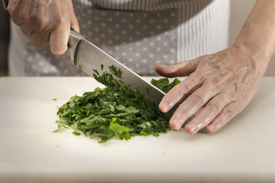 Midsection of man preparing food in kitchen