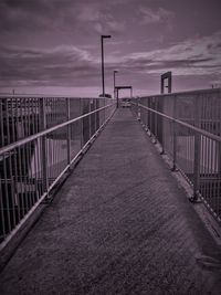 View of empty bridge against cloudy sky