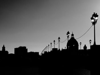 Silhouette of city against clear sky