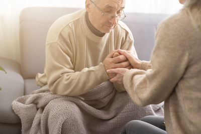 Midsection of man holding hands