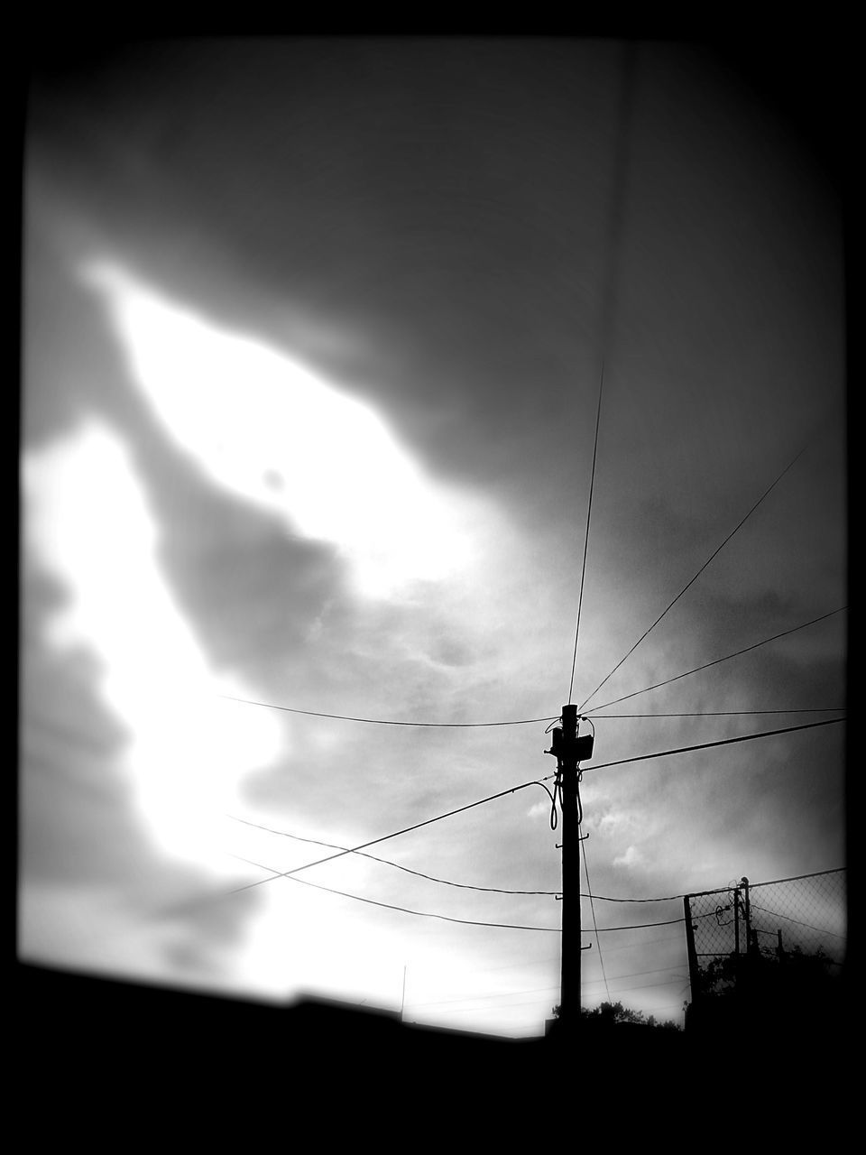 SILHOUETTE ELECTRICITY PYLON AGAINST SKY