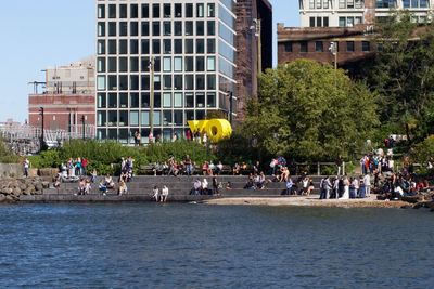 Tourists at riverbank in city