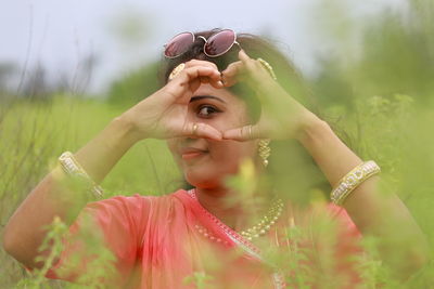 Portrait of woman holding plant