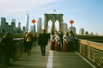 People walking on footpath in city