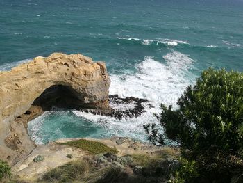 High angle view of rock by sea against sky