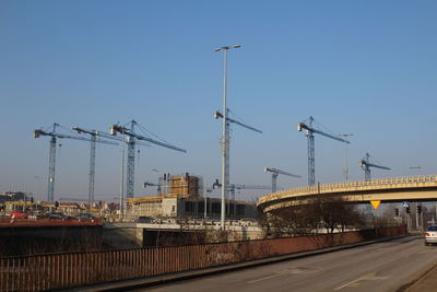 Cars on bridge in city against sky